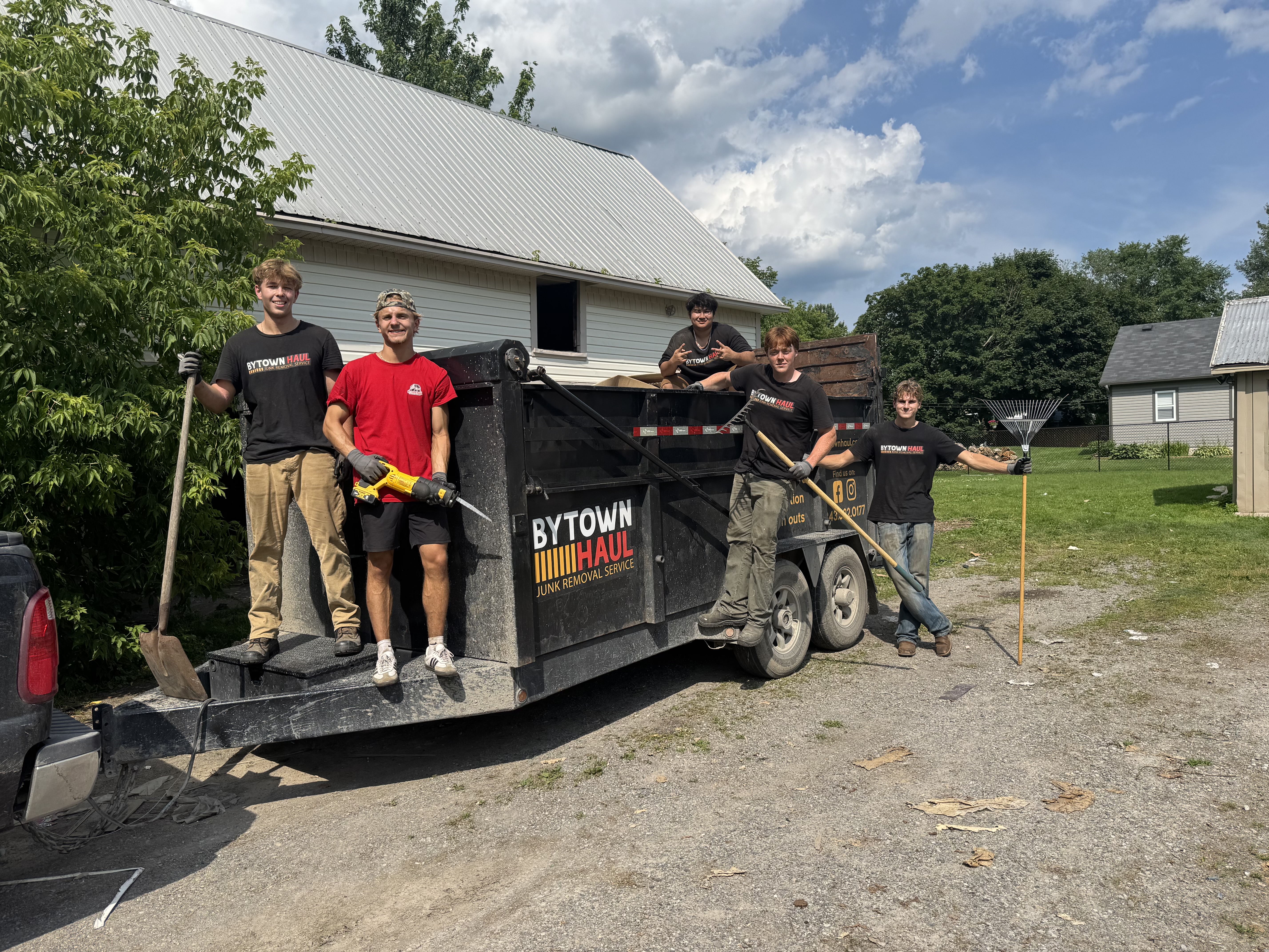 Bytown Haul 5-member student hauling crew next to branded trailer