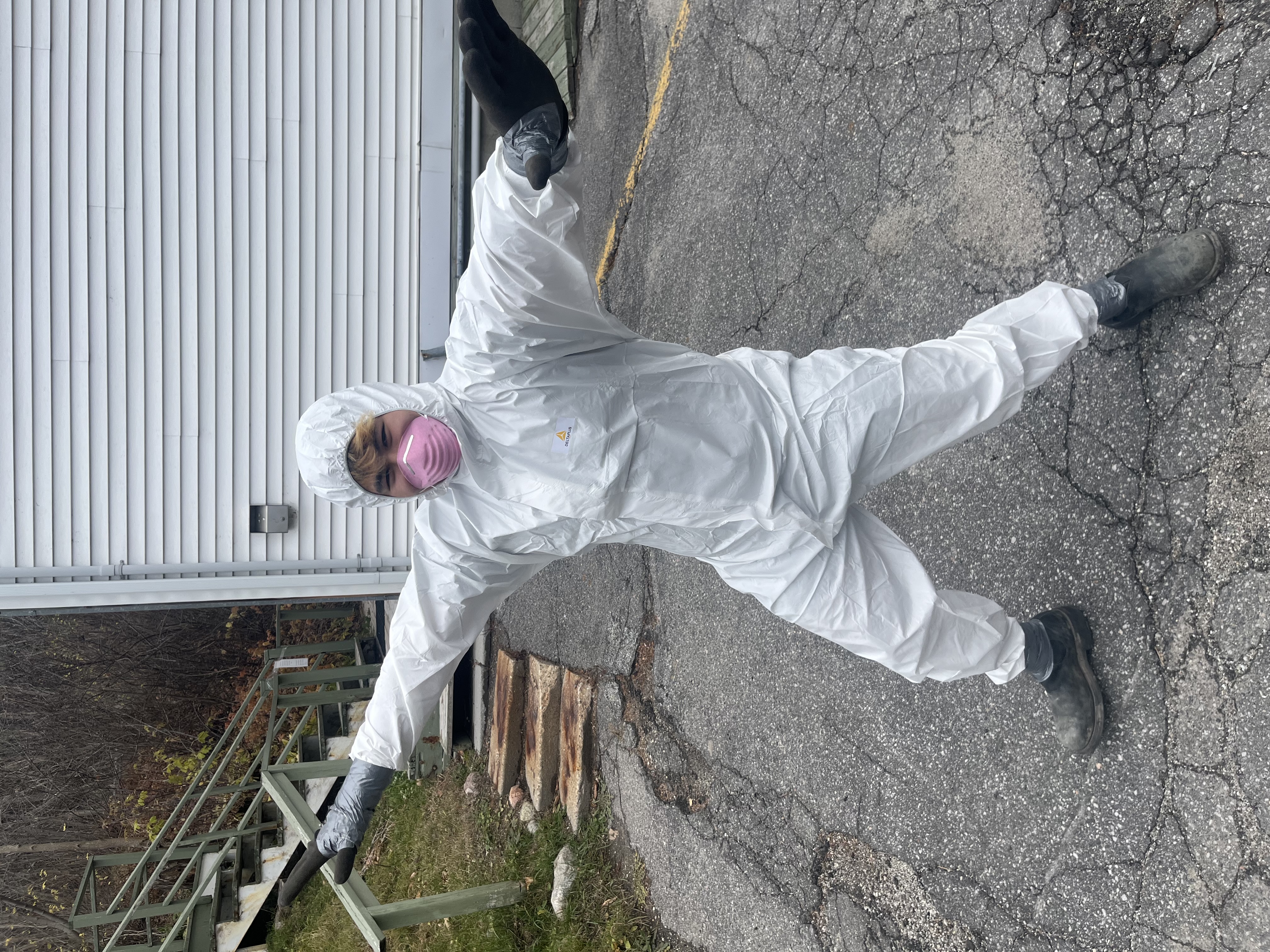 Bytown Haul crew member in protective suit and respirator